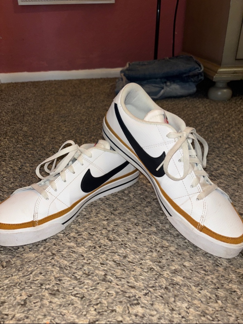 Nike White Low-Top Sneakers with Black Swoosh and Gold Trim